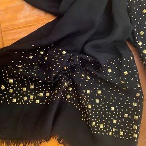 black scarf with gold embellishments .